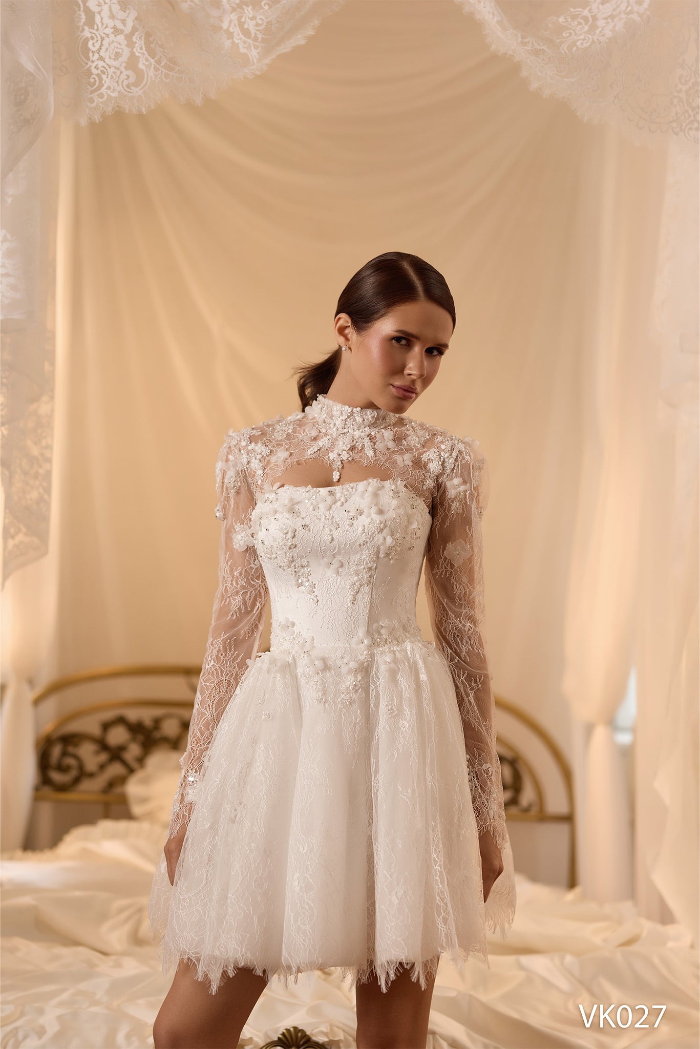 Bridal mini dress with floral appliqués, illusion high-neck lace sleeves, corset bodice, voluminous skirt, and lace-up back