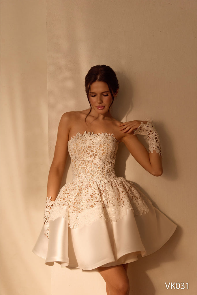 Strapless bridal mini dress with floral lace bodice, sculpted peplum waist, and flared skirt