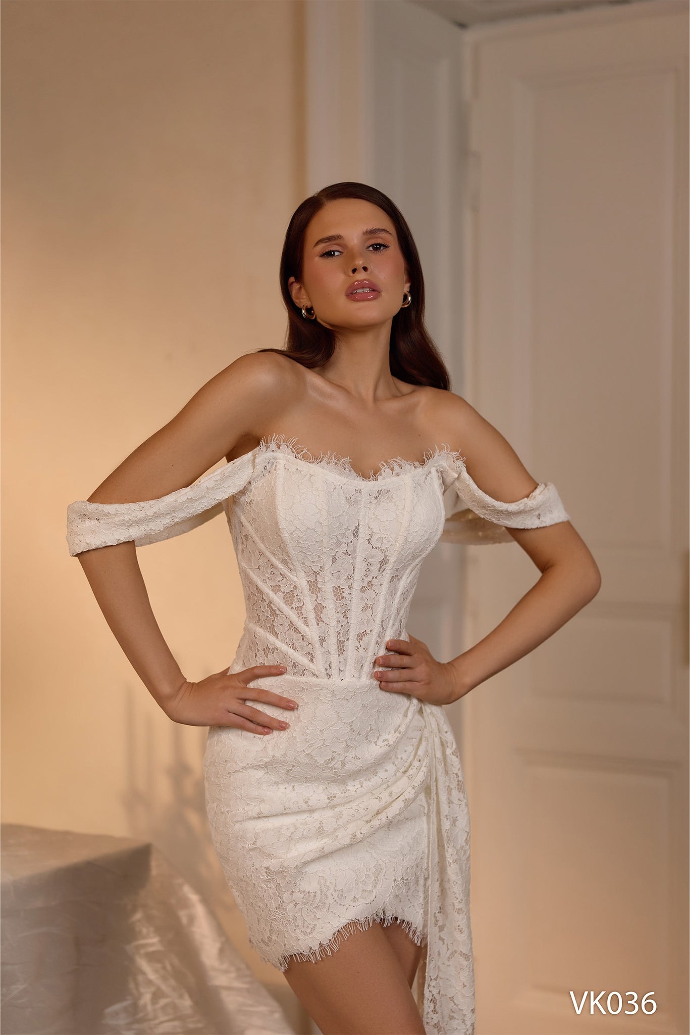 Lace bridal mini dress with structured corset bodice, off-the-shoulder sleeves, and draped fitted skirt