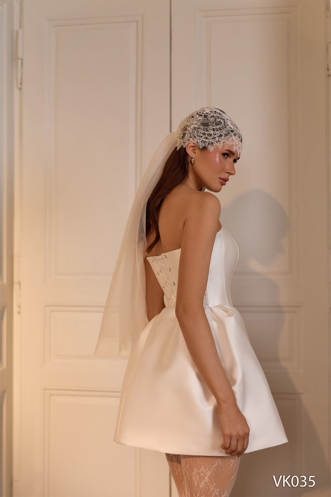 Strapless bridal mini dress with sculpted bubble skirt silhouette and structured corset bodice