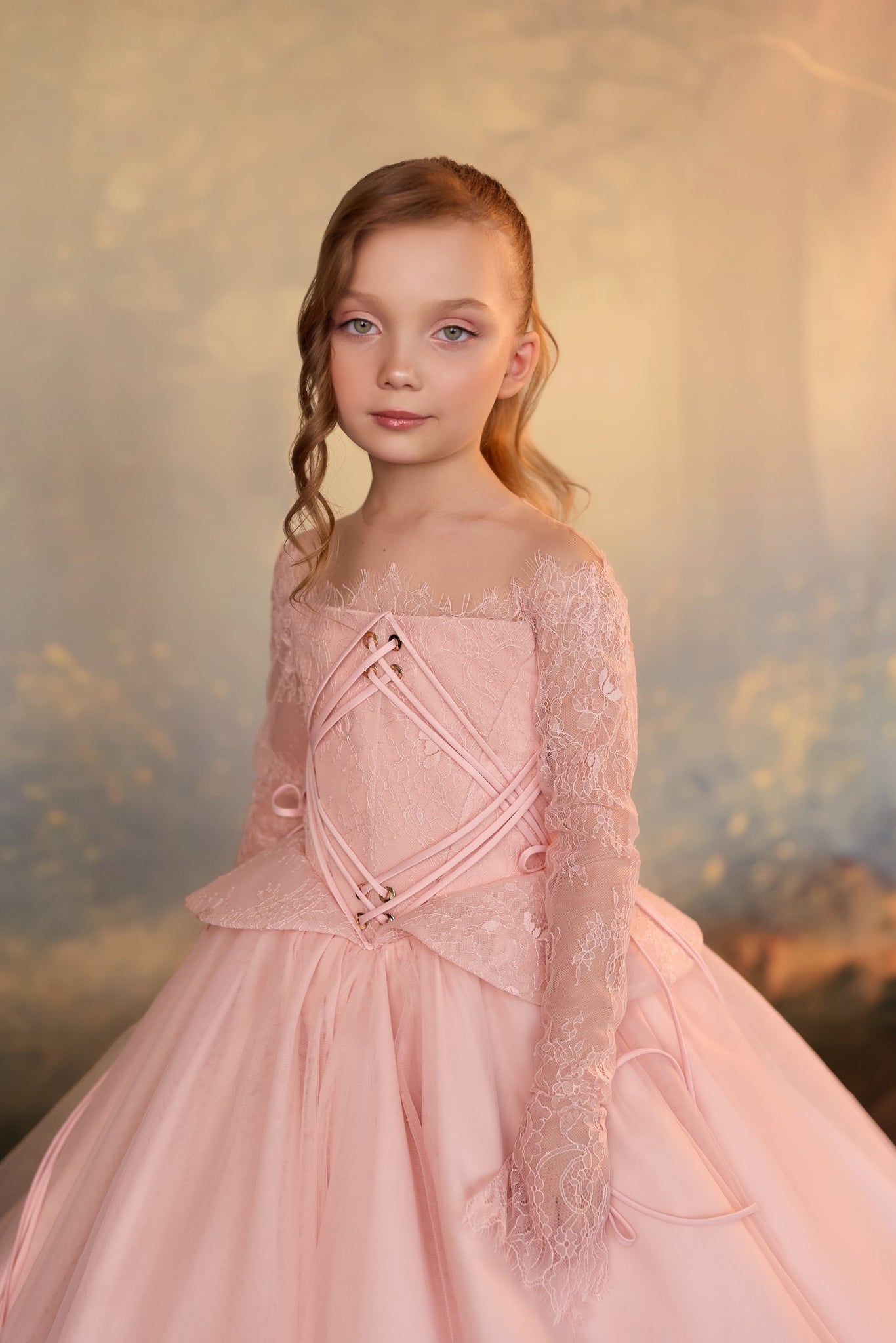 Girl wearing a pink lace corset dress with long sleeves | Girls Formal Dress