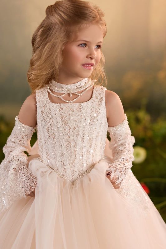 Girl wearing a cream lace dress with pearl choker and matching lace sleeves