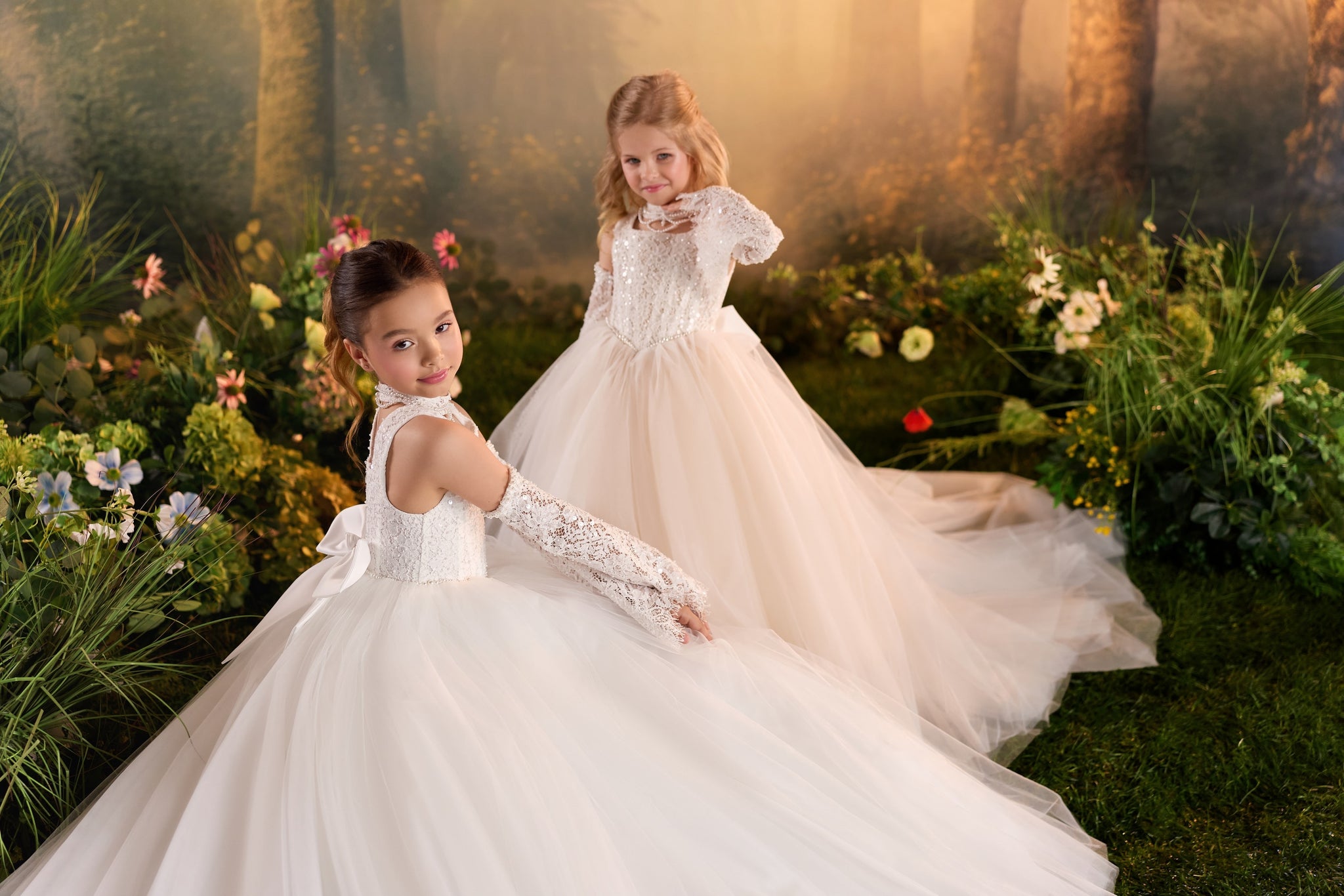 Two girls wearing white lace ball gowns in a garden setting | Girls Formal Dress