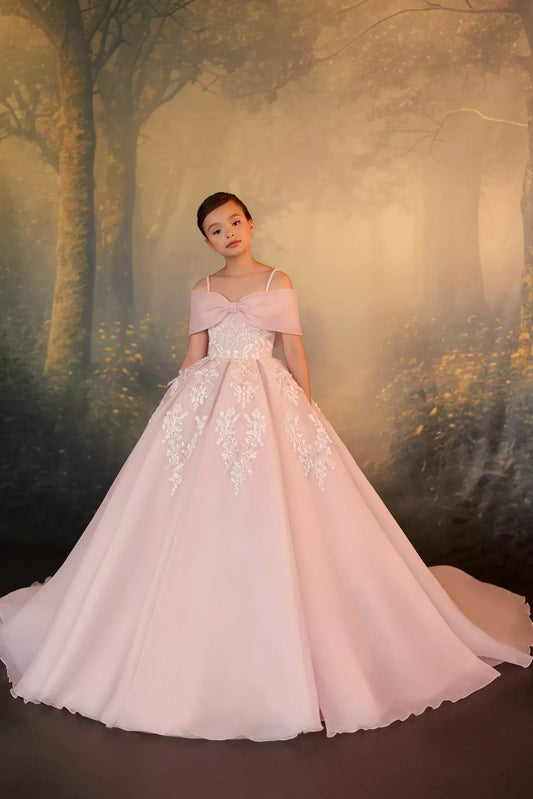 Girl wearing a pink off the shoulder ball gown with white lace embroidery