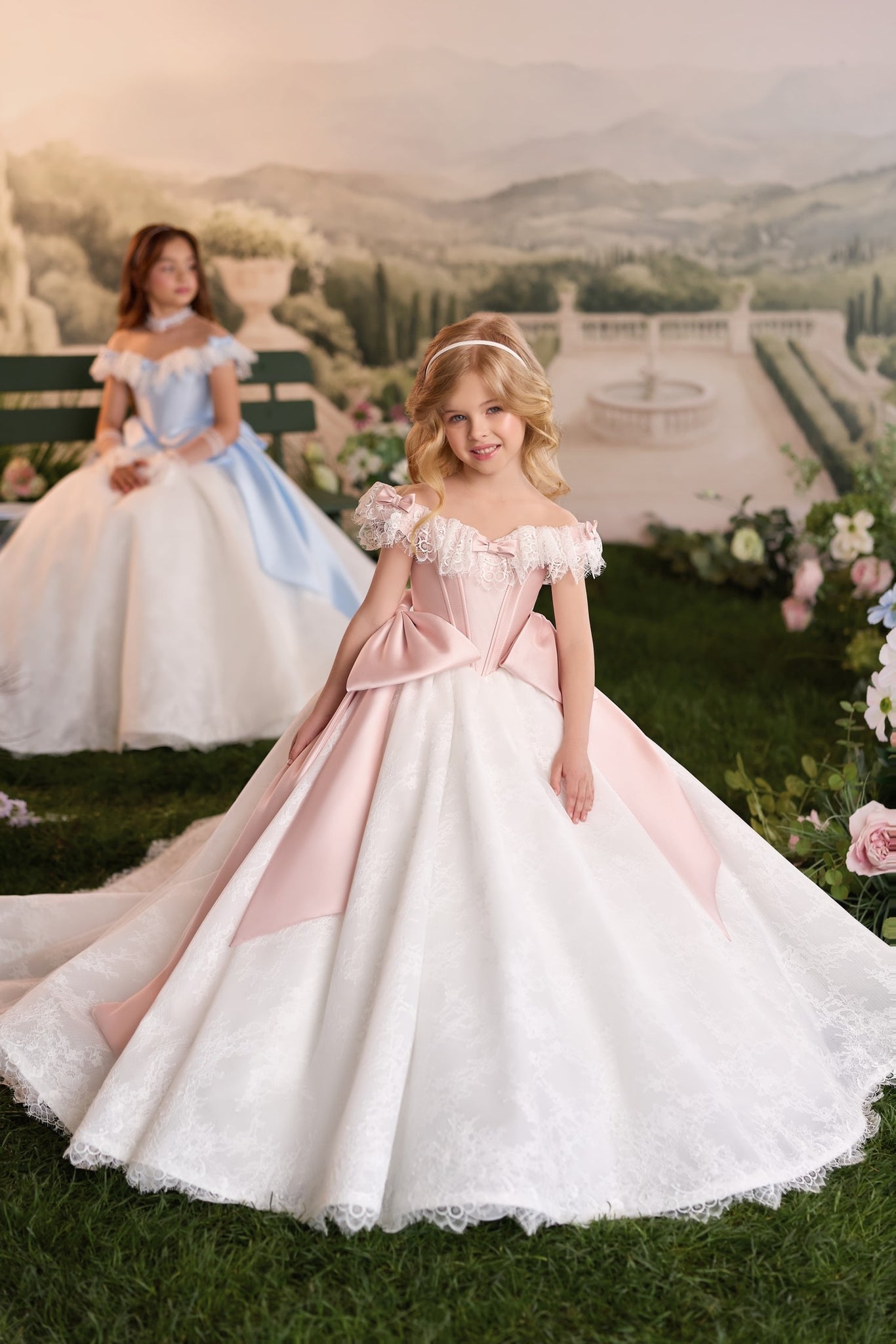 Girl wearing a pink and white off the shoulder ball gown with lace details