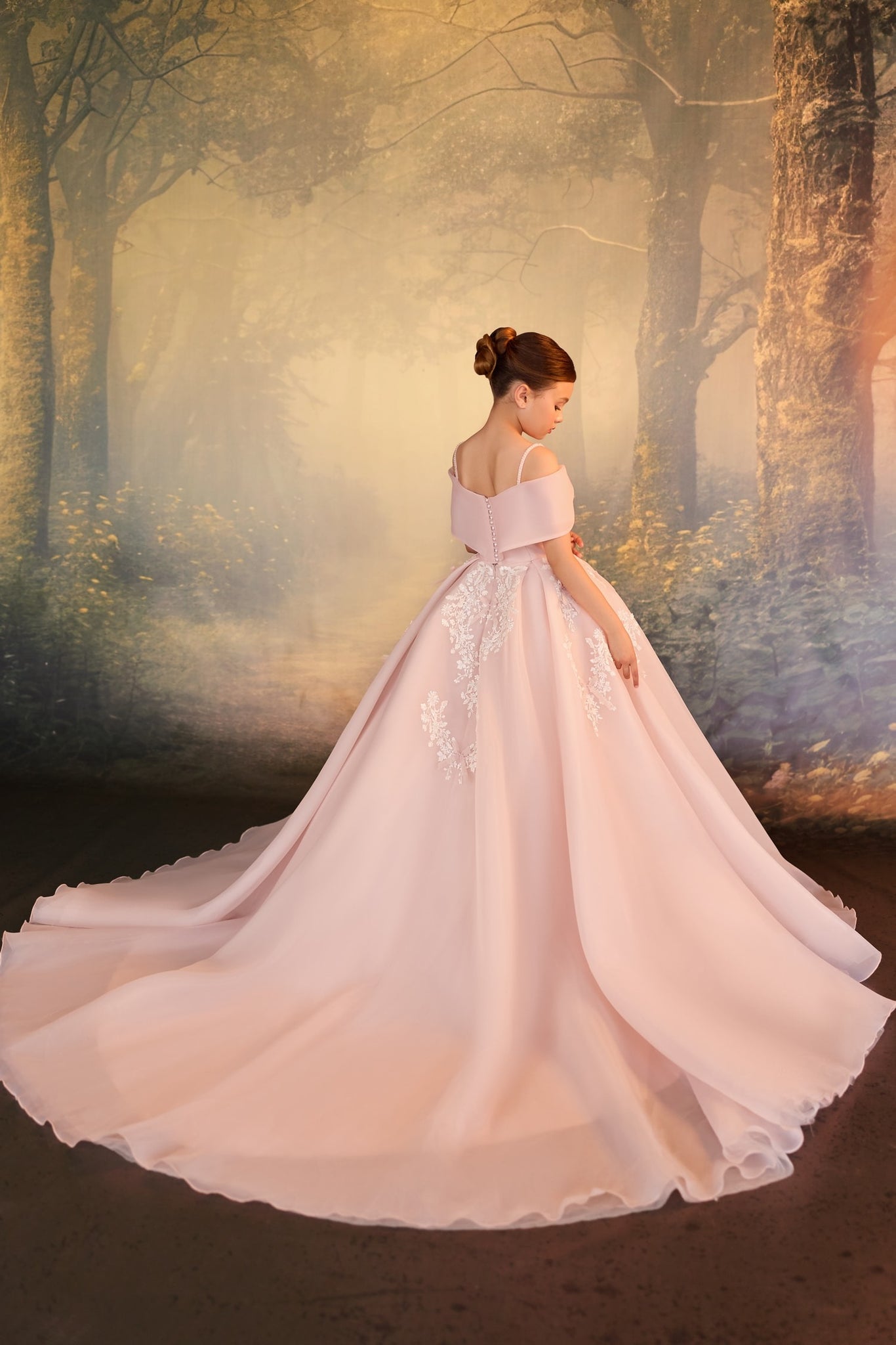 Girl wearing a pink off the shoulder ball gown with white lace details and a long train against a forest backdrop