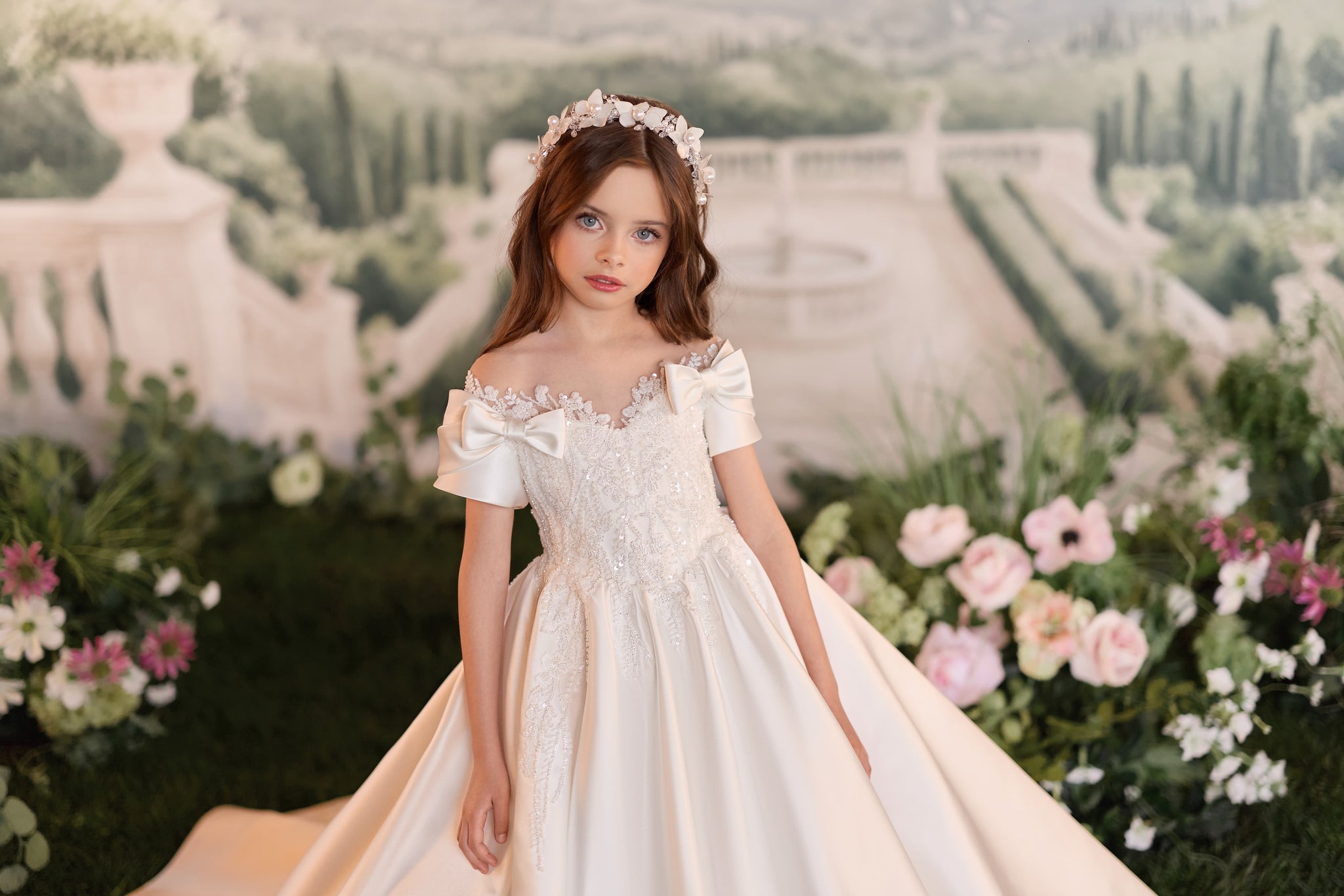 Girl wearing white off shoulder ball gown with floral headband
