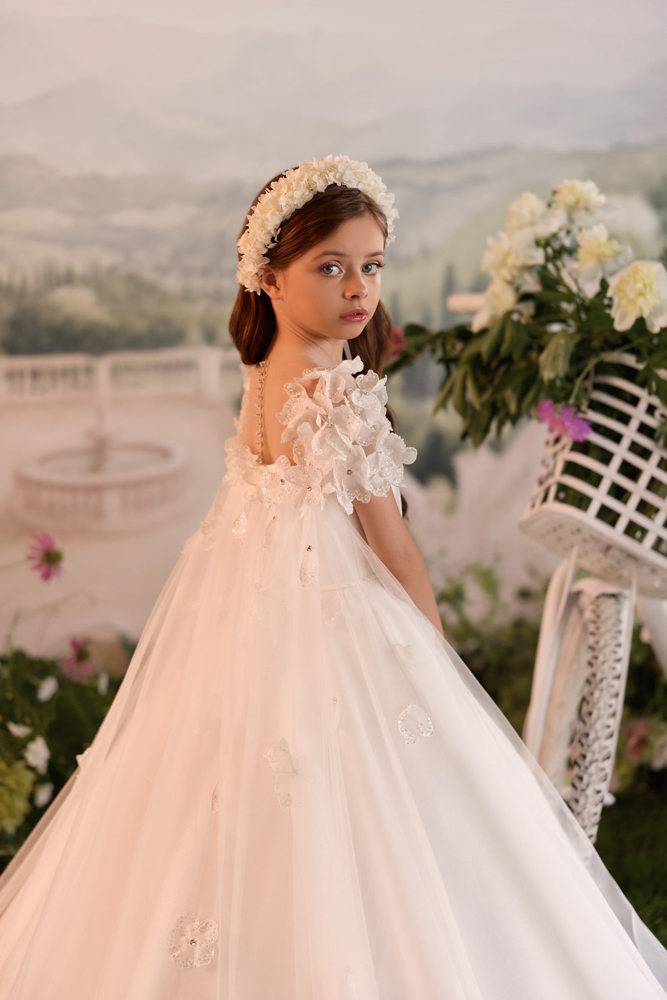 Girl wearing a white floral dress and matching headband