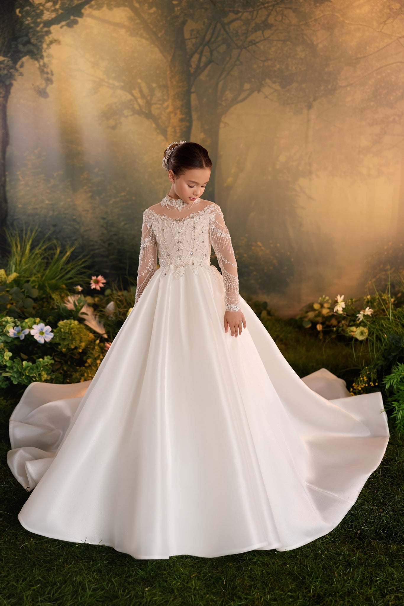 Girl wearing a white long sleeve ball gown with lace and bead embellishments
