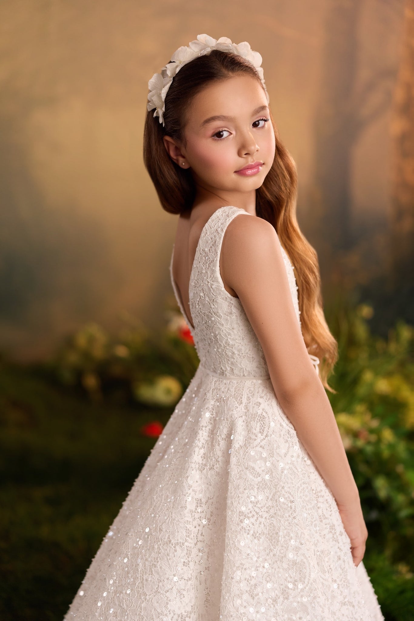 Girl wearing a white lace dress and a floral headband