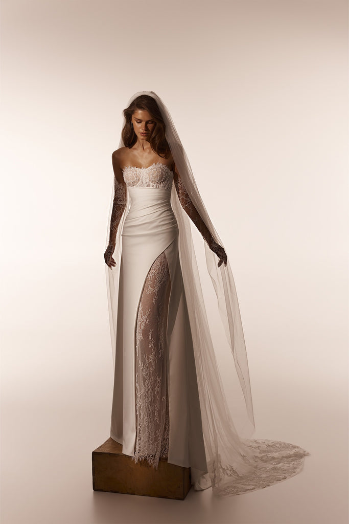 Strapless wedding dress with lace bodice and side slit with lace underlay and matching veil