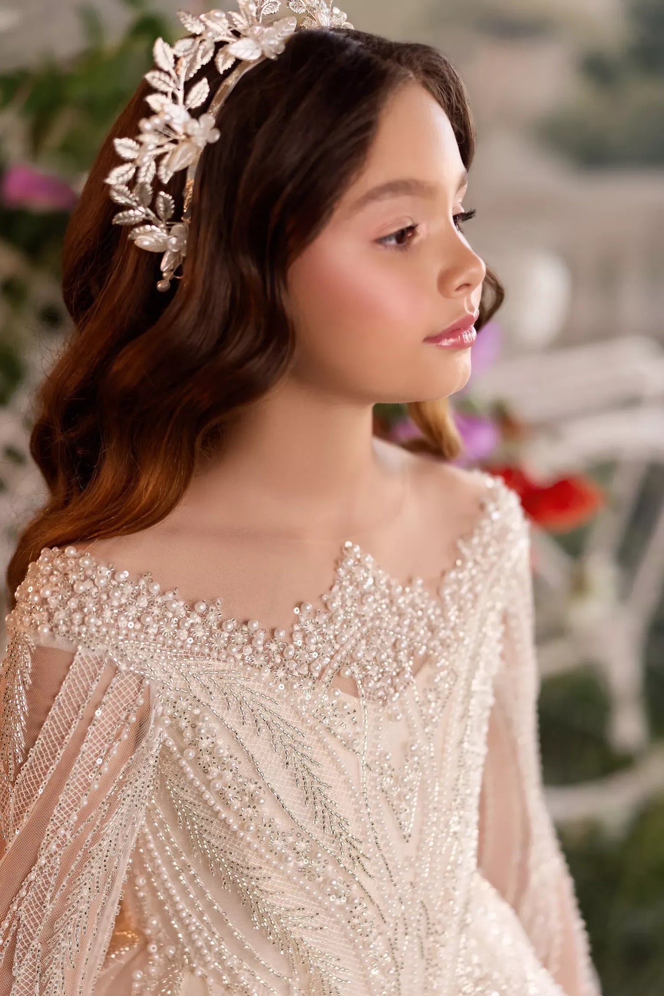 Girl wearing a beaded dress and a floral leaf headband