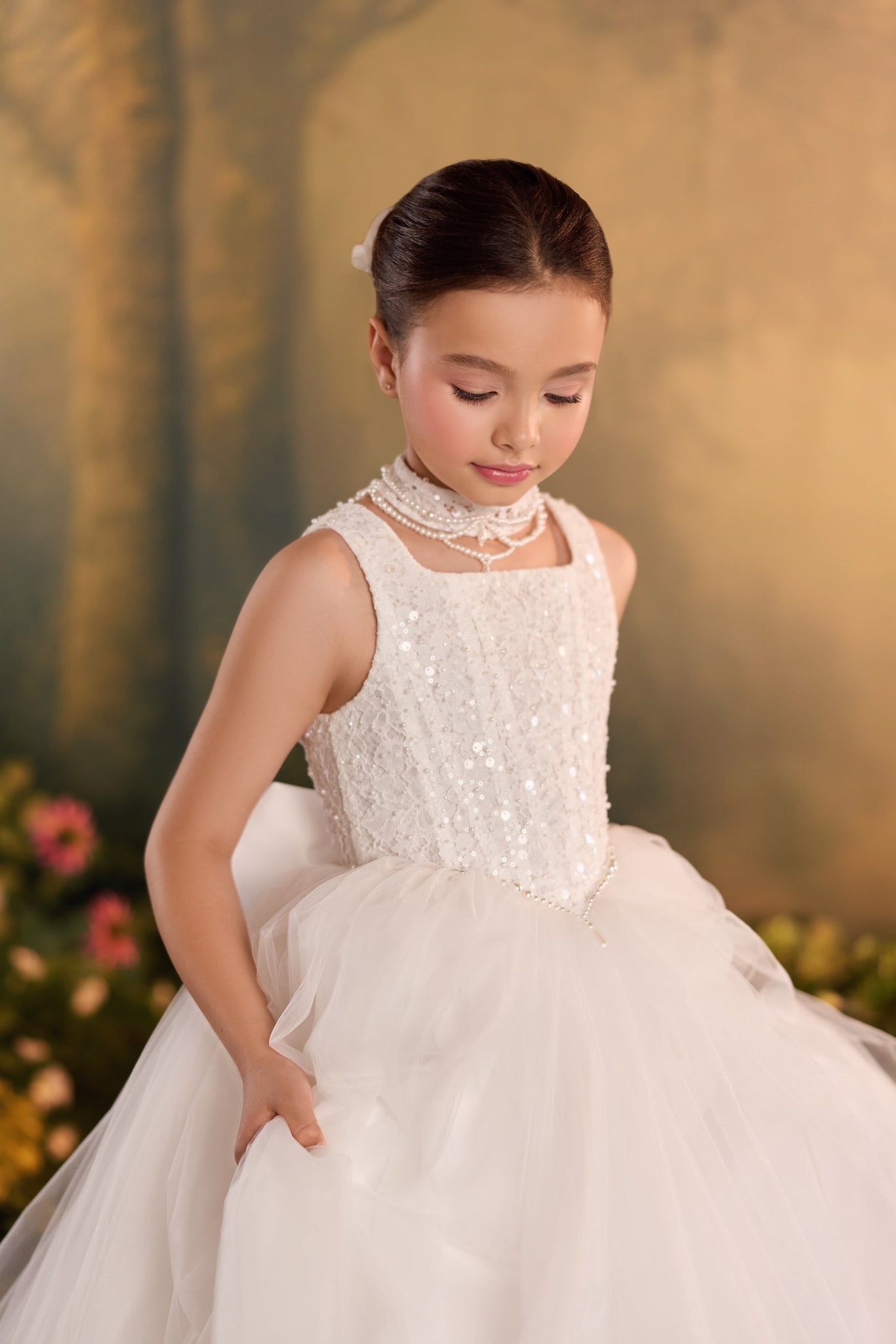 Girl wearing a white sequined lace bodice dress with a tulle skirt and pearl choker | Girls Formal Dress