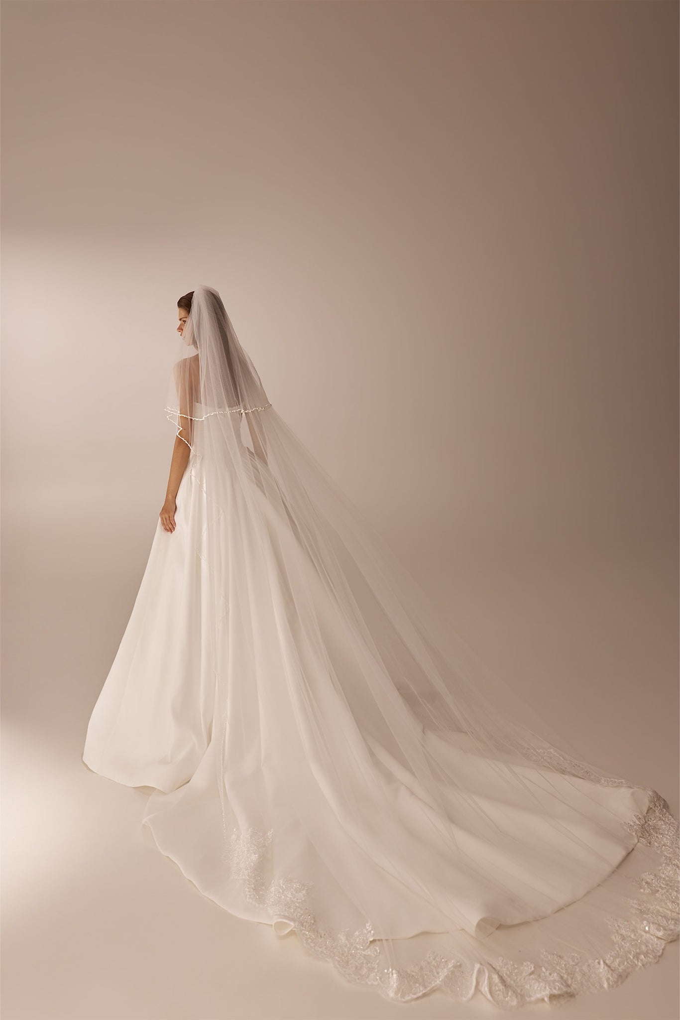 Bride wearing a long white wedding dress with a floor length veil