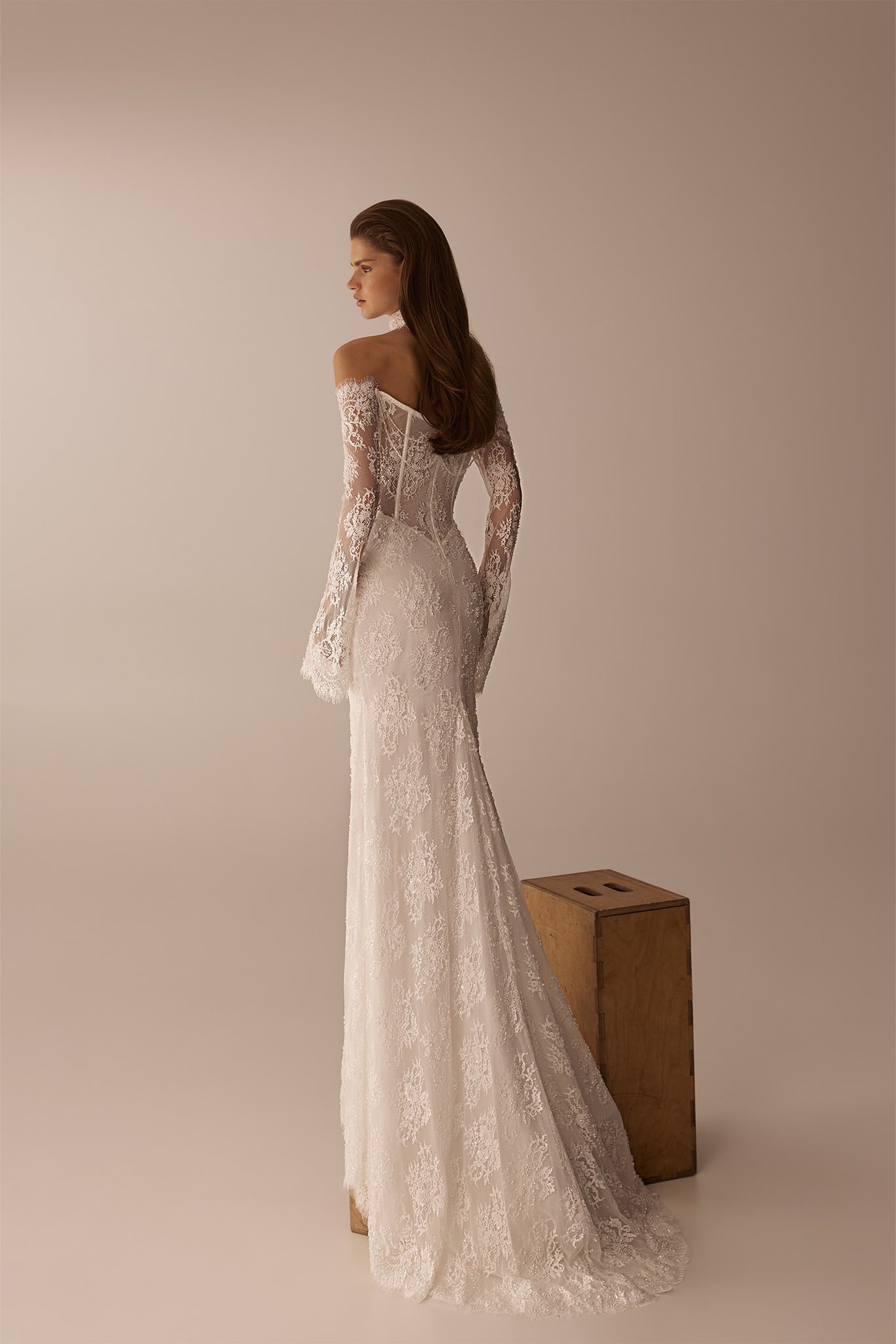 Woman wearing a long sleeve off the shoulder lace wedding dress