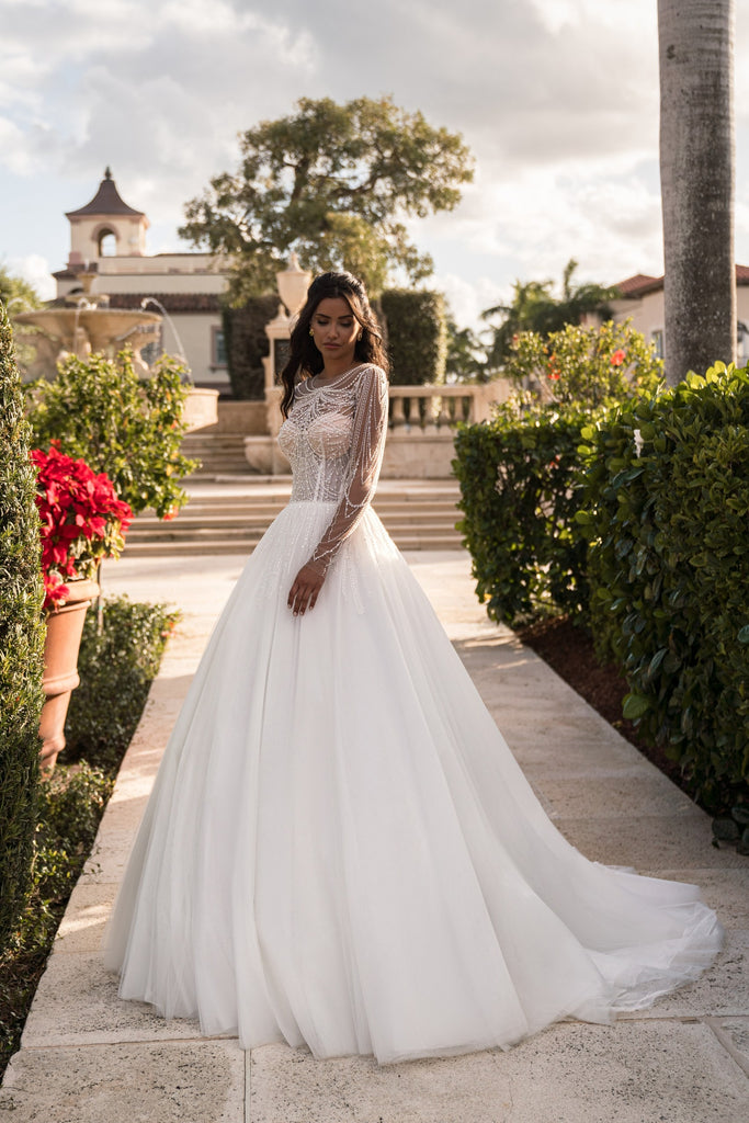 EMABRIDE 264 ball gown wedding dress with high illusion neckline, long sleeves, embellished bodice, and sweeping full skirt