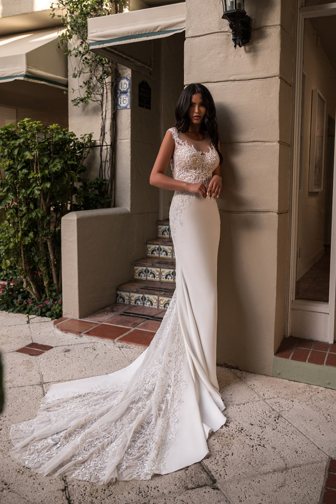 EMABRIDE 271 fitted wedding dress with narrow straps, curved neckline, embellished bodice, and long dramatic train