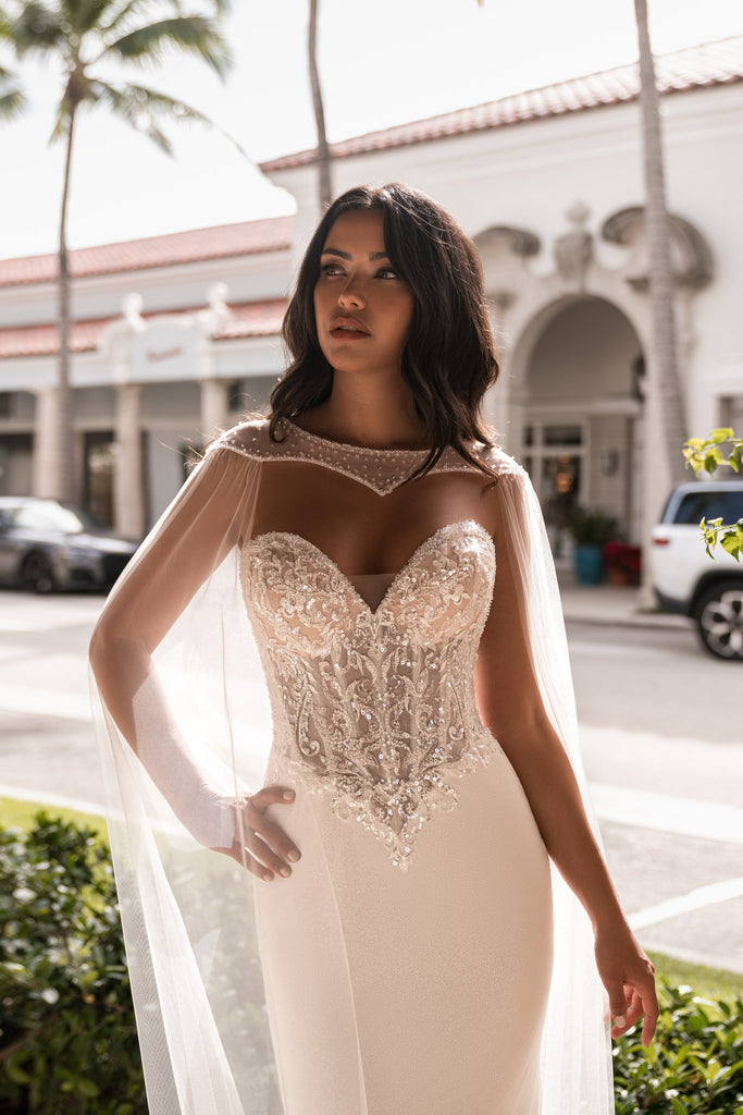 EMABRIDE 278 fitted wedding dress with sweetheart corset bodice, sheer cape neckline, long sleeves, and ornate embroidery