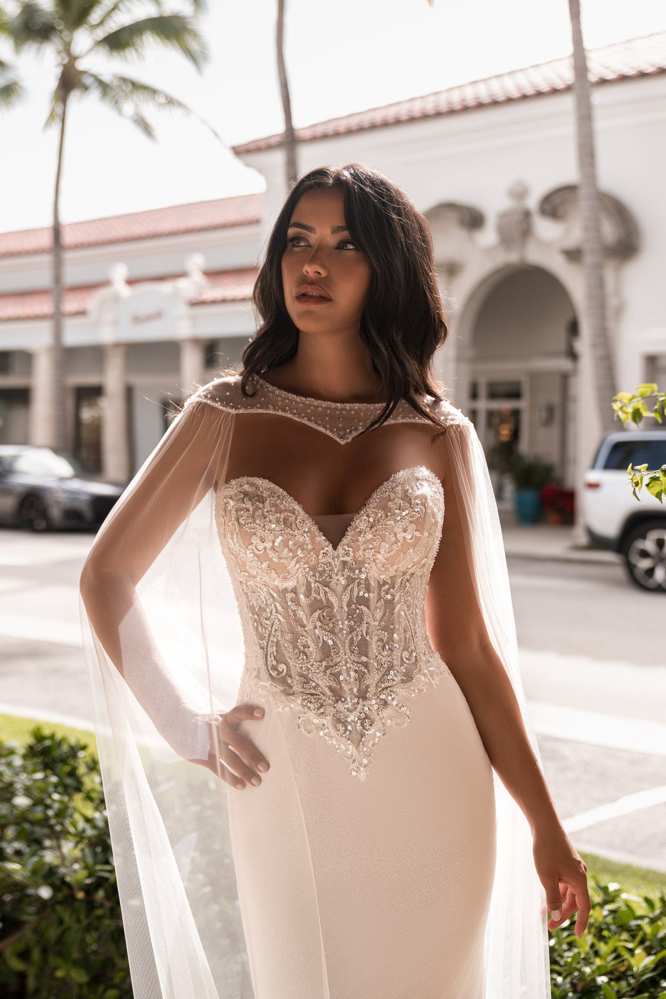 EMABRIDE 278 fitted wedding dress with sweetheart corset bodice, sheer cape neckline, long sleeves, and ornate embroidery