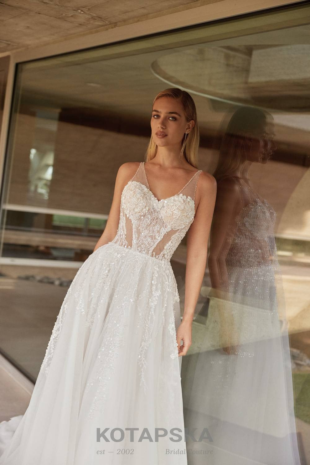 Airy A-line wedding dress with a semi-sheer lace corset bodice, delicate straps, soft tulle skirt, and subtle shimmer detailing
