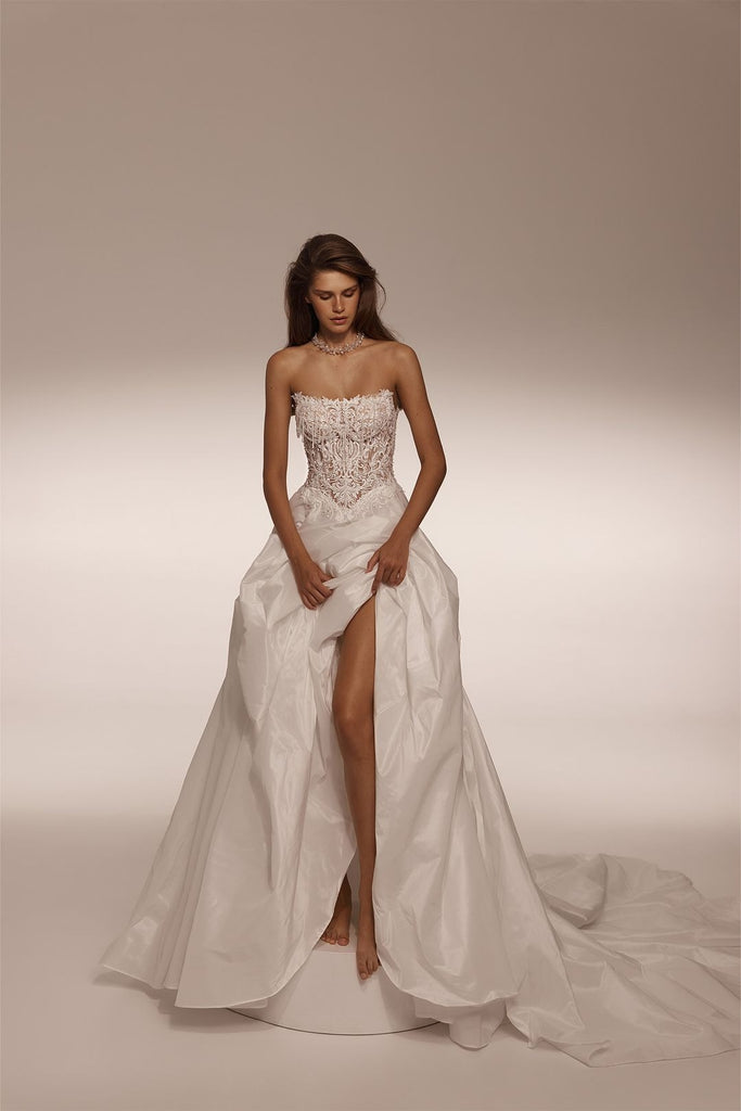 Strapless wedding dress with lace corset bodice and full skirt with high leg slit