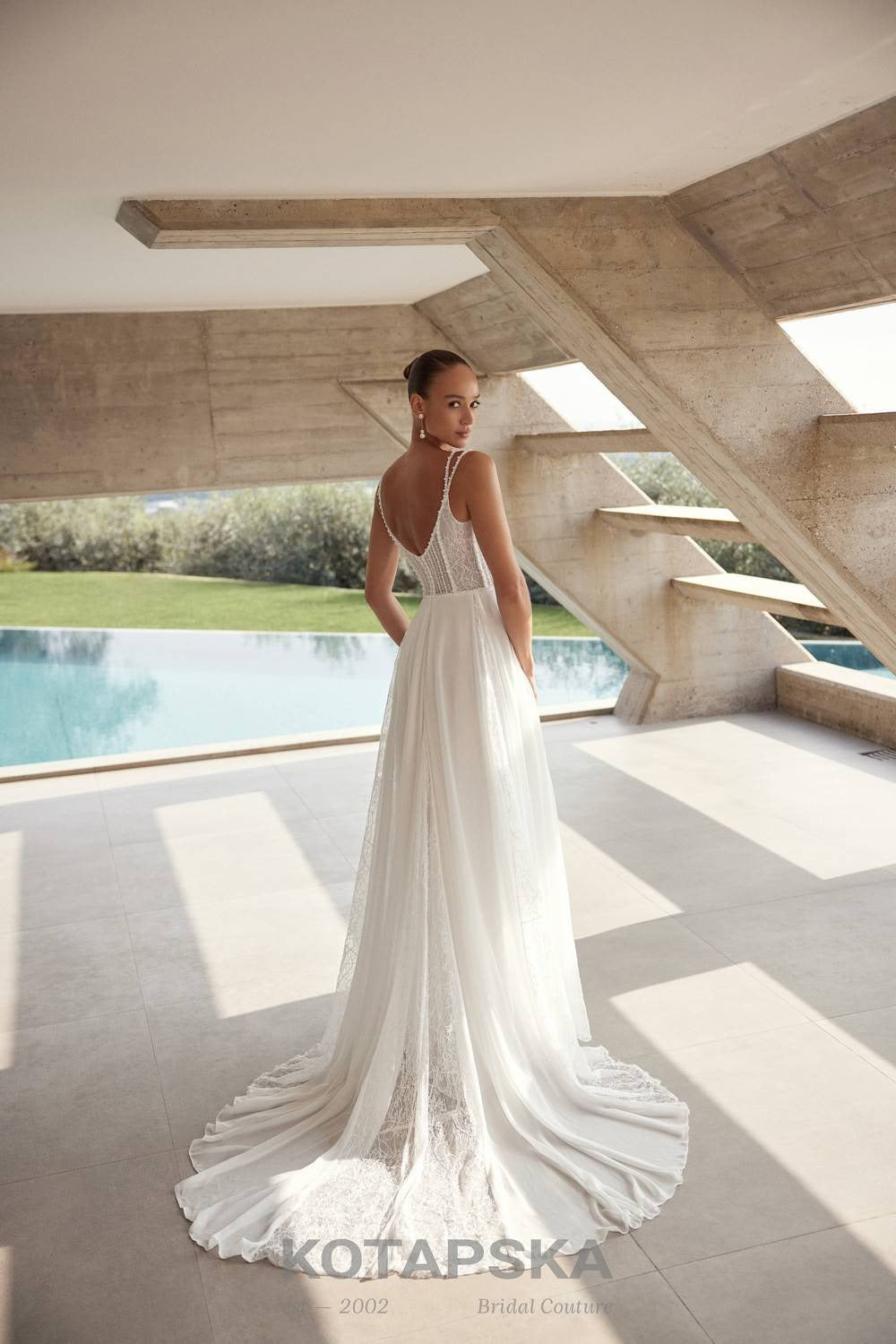 Airy A-line wedding dress with a lace corset bodice, delicate straps, flowing chiffon skirt, lace inserts, and detachable long sleeve lace topper