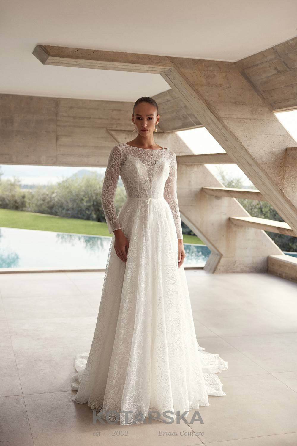 Airy A-line wedding dress with a lace corset bodice, delicate straps, flowing chiffon skirt, lace inserts, and detachable long sleeve lace topper