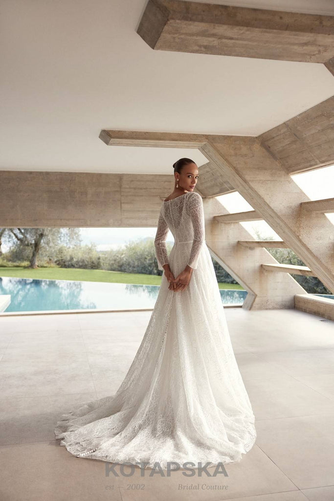 Airy A-line wedding dress with a lace corset bodice, delicate straps, flowing chiffon skirt, lace inserts, and detachable long sleeve lace topper