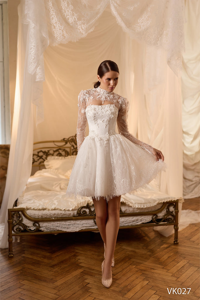Bridal mini dress with floral appliqués, illusion high-neck lace sleeves, corset bodice, voluminous skirt, and lace-up back