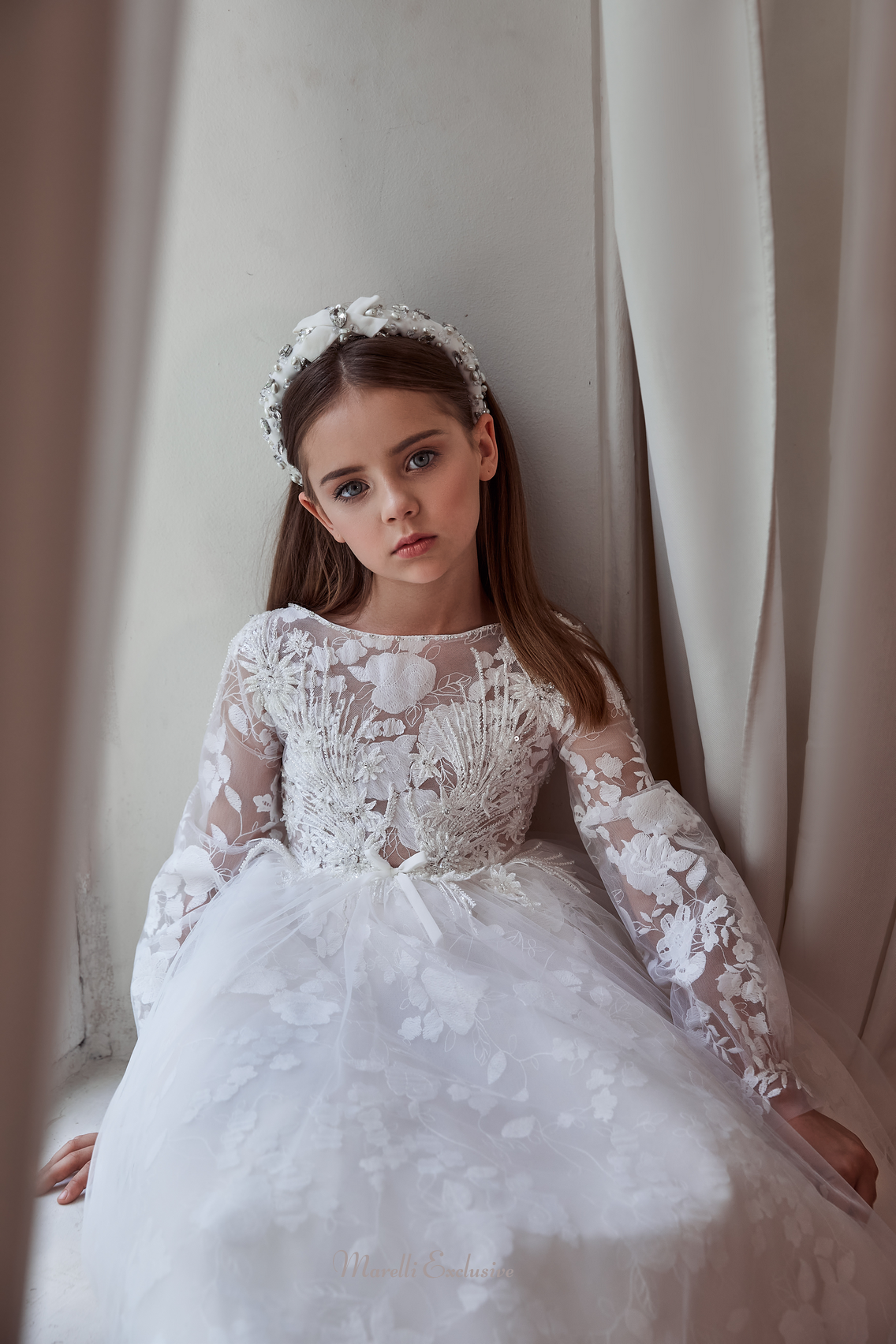 Pentelei 3113 elegance in floral lace: a dress with long lace sleeves and a dramatic train  | Girls Formal Dress